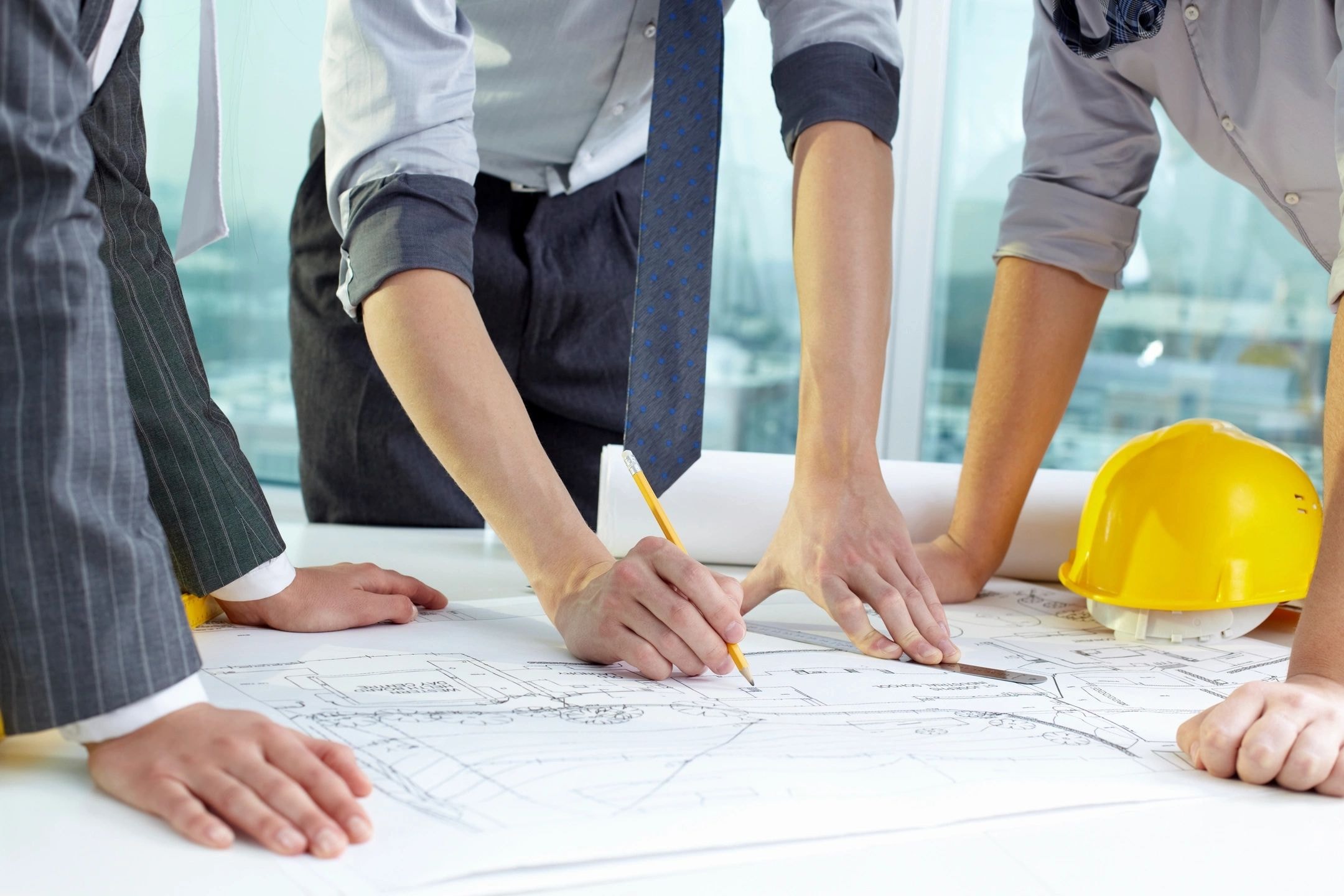 Business professionals reviewing blueprints